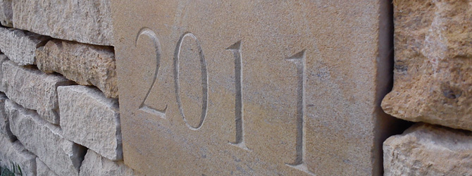 Date Stone with hand dressed dry stone wall